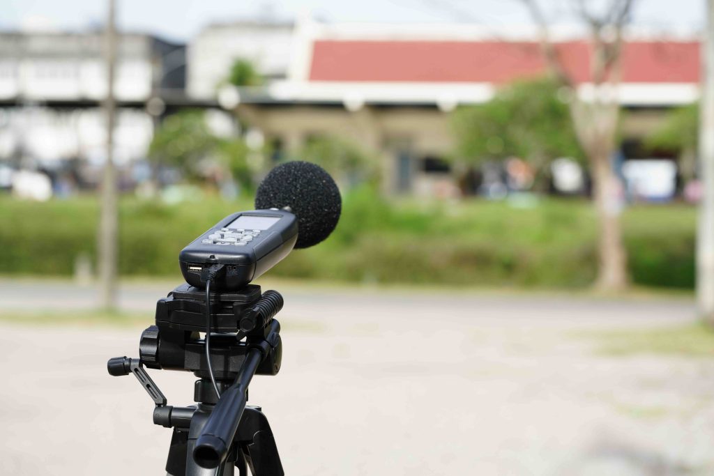 Sound level meter set up on site during a noise survey to measure environmental noise levels